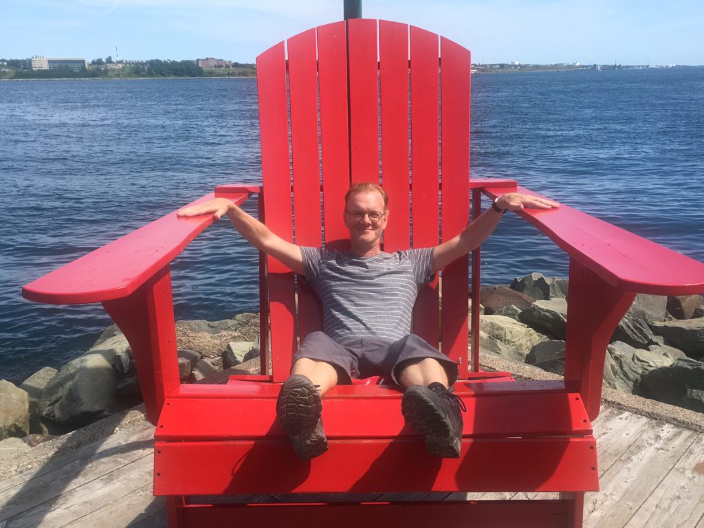 Diccon Bewes sitting in a giant chair