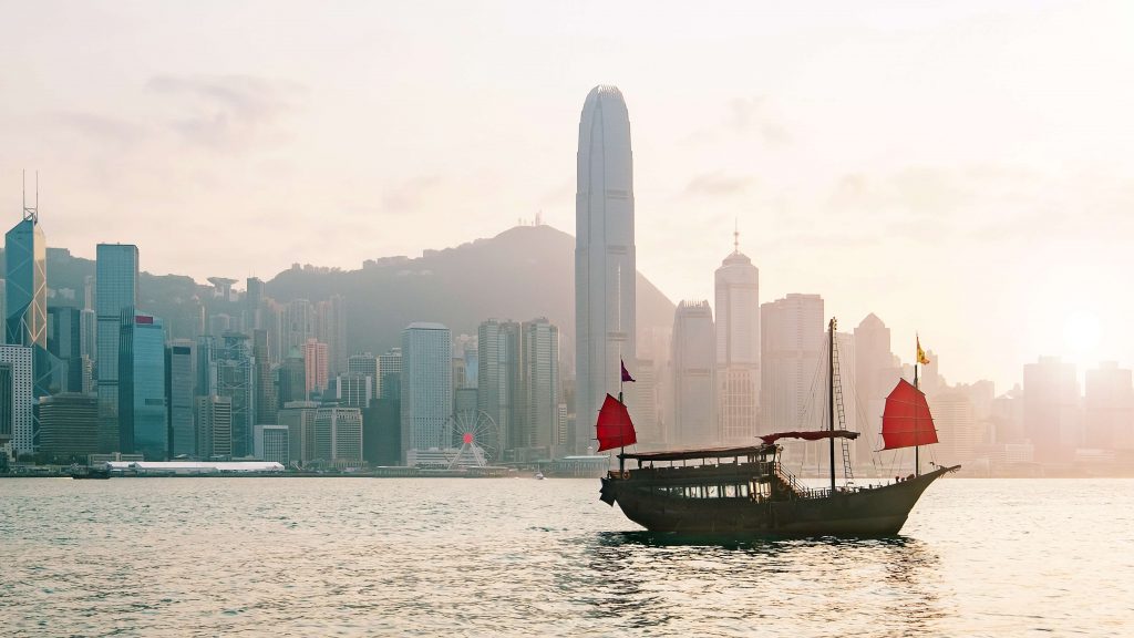 A boat in Victoria Harbour with Hongkong Skyline in the back.