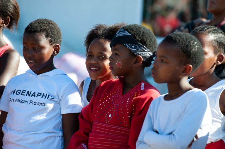 A group of young children standing next to each other