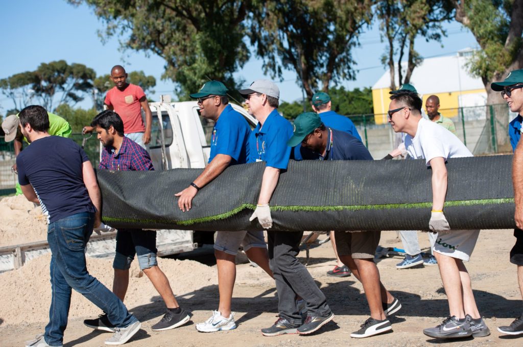 Group of people carrying a large object