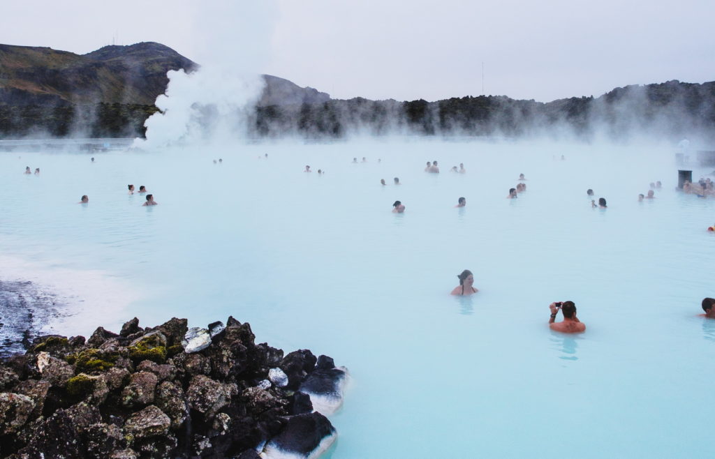 People swimming in the hot springs of blue lagoon in Iceland