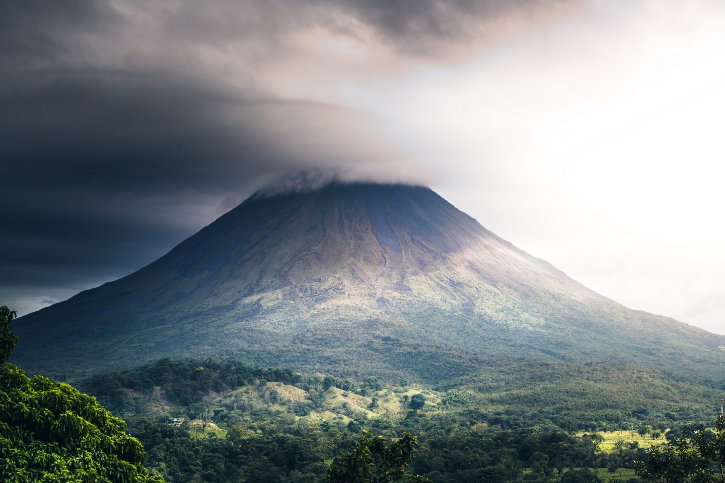 The still active Arenal volcano with clouds and jungle of Costa Rica.