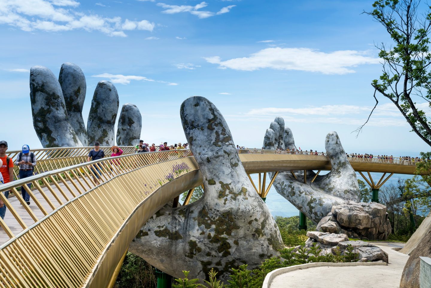 The Golden Bridge is lifted by two giant hands in the tourist resort on Ba Na Hill in Danang, Vietnam
