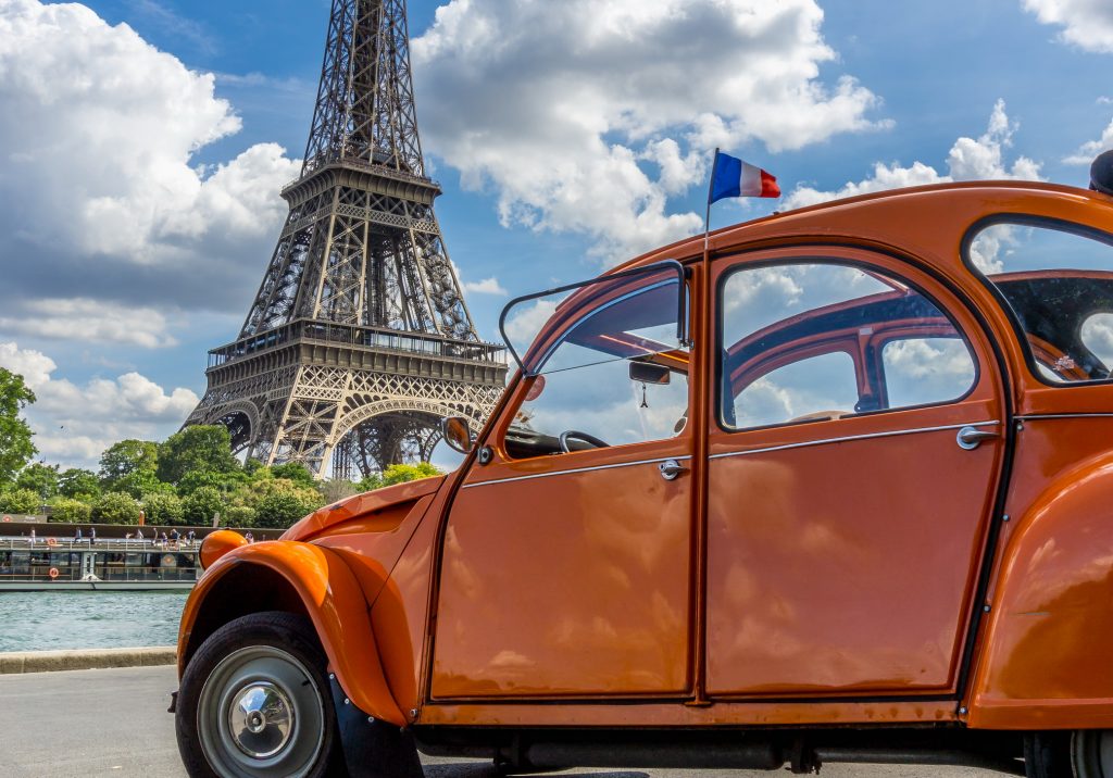 The Eiffel Tower and a Citroen 2CV are two typical Parisian symbols.