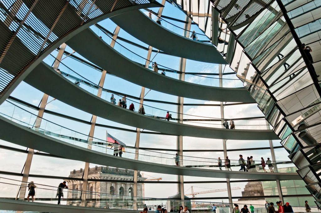 Visit the glass Reichstag dome that symbolizes the reunification of Germany.