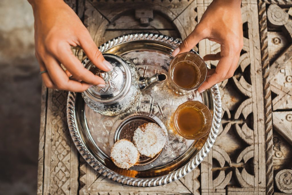 Experience Moroccan hospitality with a traditional mint tea ceremony with fresh biscuits.