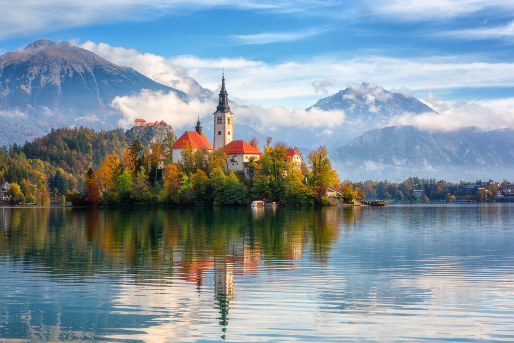 Ride a traditional pletna boat on beautiful lake bled in Slovenia