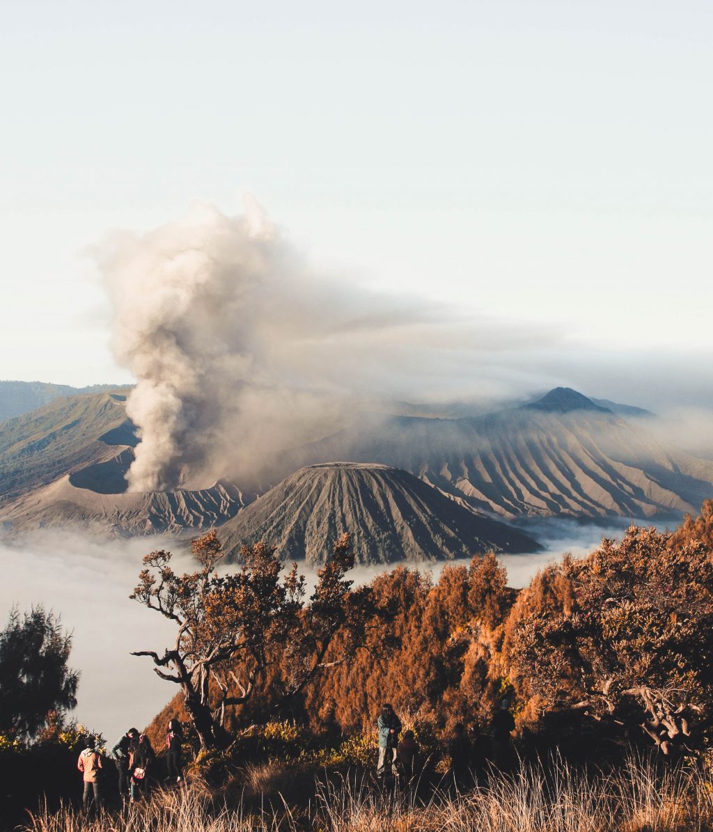 Tourist admiring volcano smoke