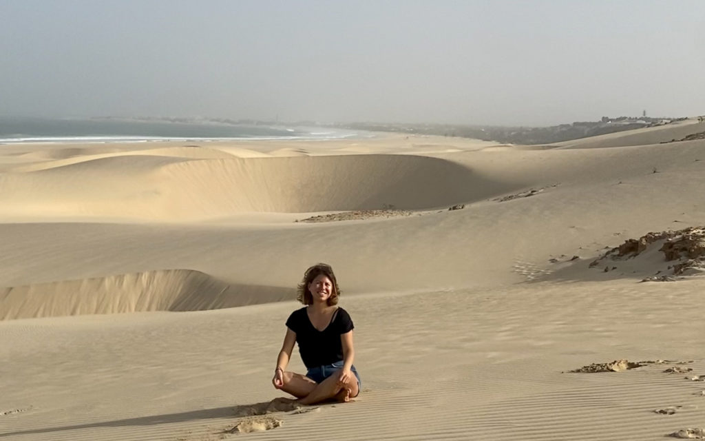 Cheerful lifestyle in summer sitting on sand dune