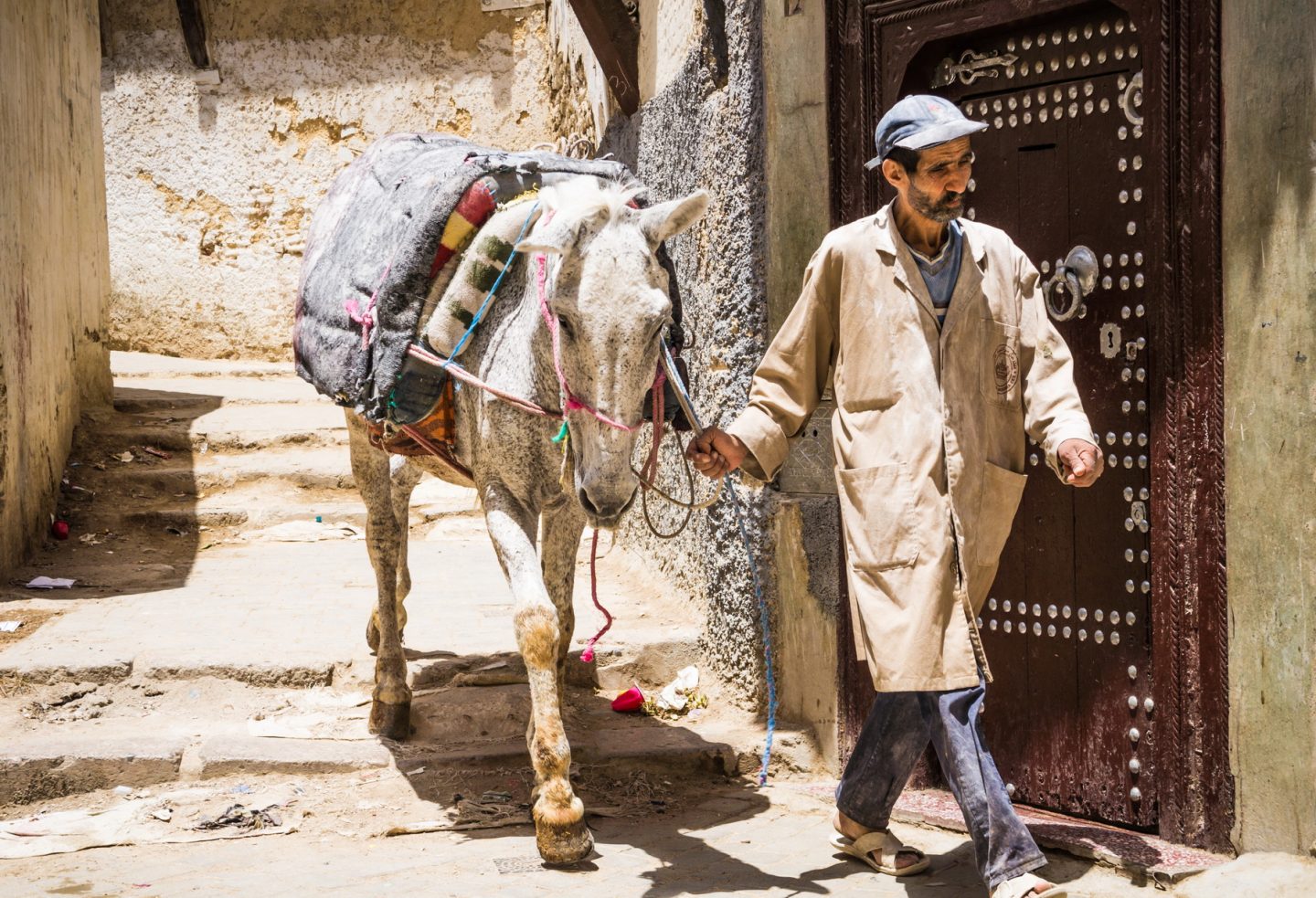 A man and his donkey in the narrow streets of the old medina of Fez in Morocco.