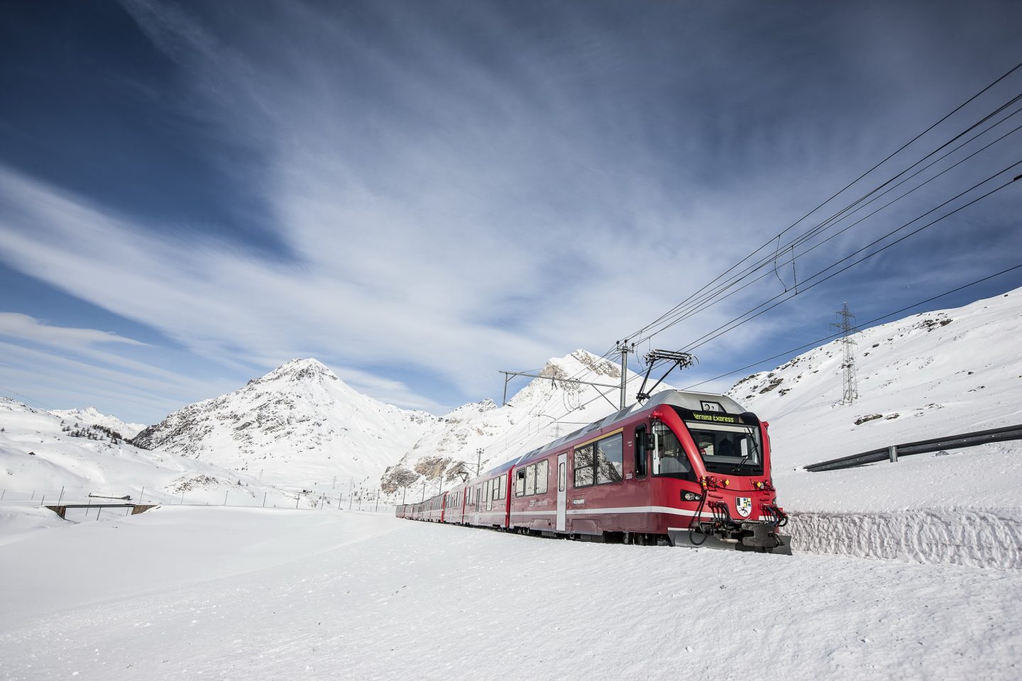 The famous red train on the snowy Bernina Pass.