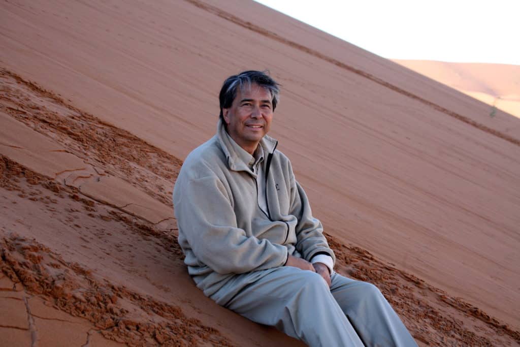 George Mueller sitting in a desert