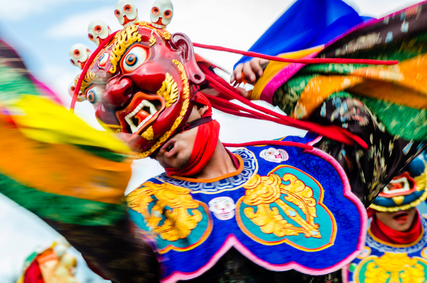 Masked dancer in a colorful dress at a tradition in Bhutan