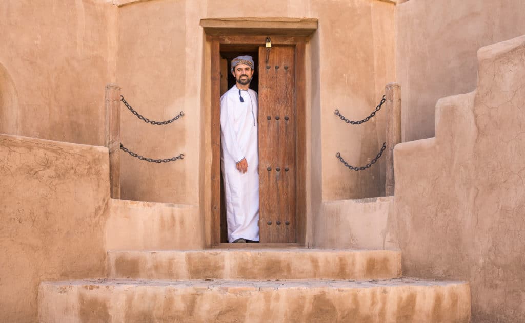 Omani men wear a simple robe, called dishdasha