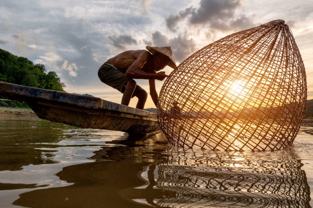 Fishermen fishing in the Mekong River in the early morning in Cambodia.