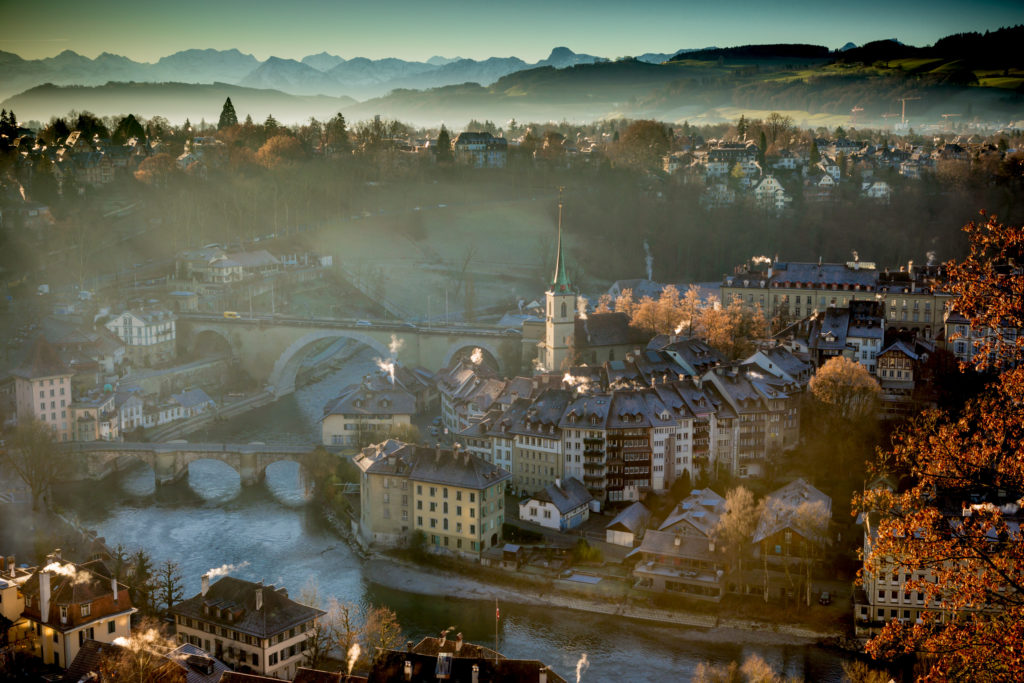 Bern, Switzerland, winter charm along the Aare River, with the picturesque Alps as a backdrop