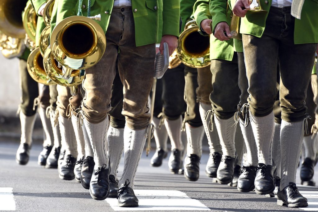A brass band in lederhosen marches in Germany.