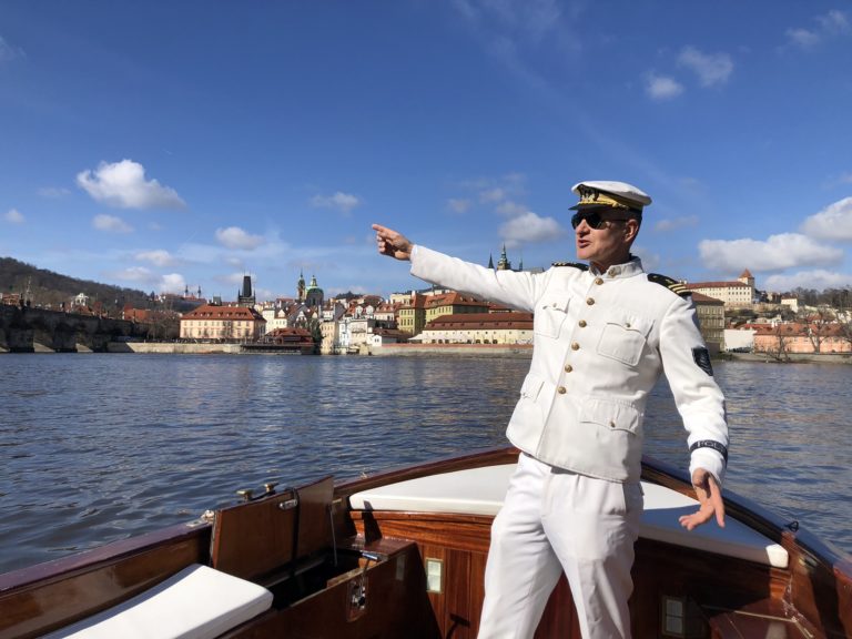 Boat captain standing up and showing the sighst from the river