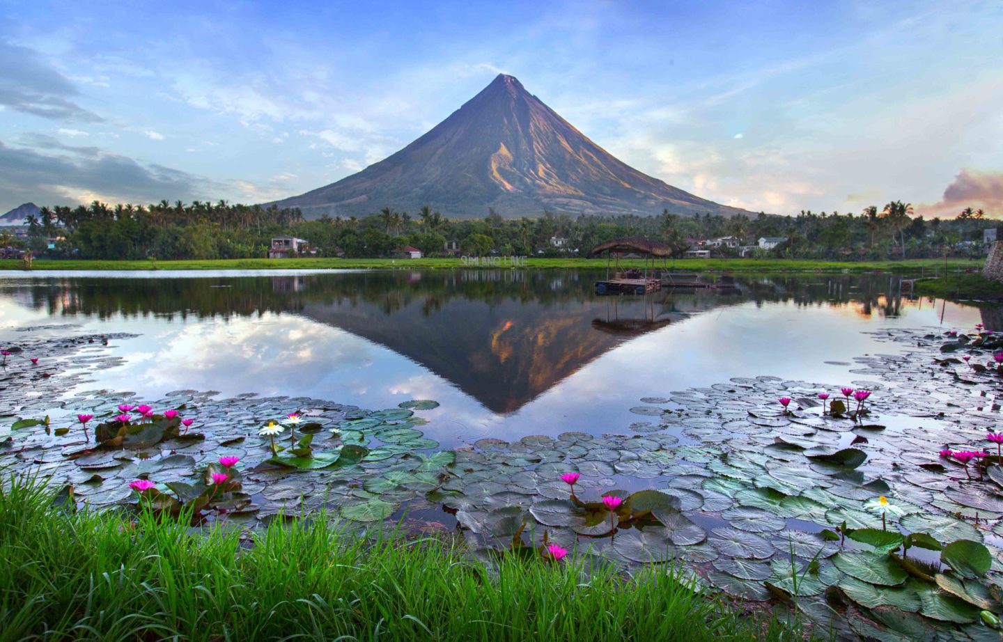 Mayon Volcano in the Philippines at early morning with its majestic silhouette against the rising sun.