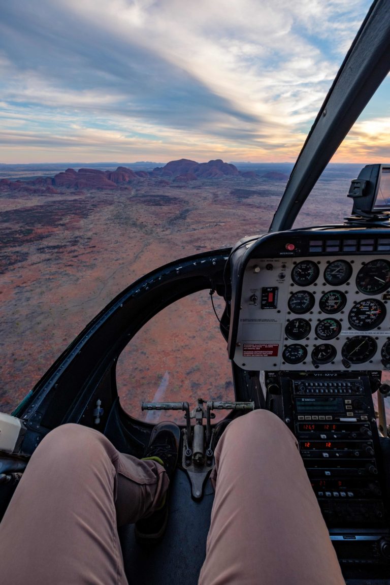 Aerial view of a desert landscape from the cockpit of a helicopter.