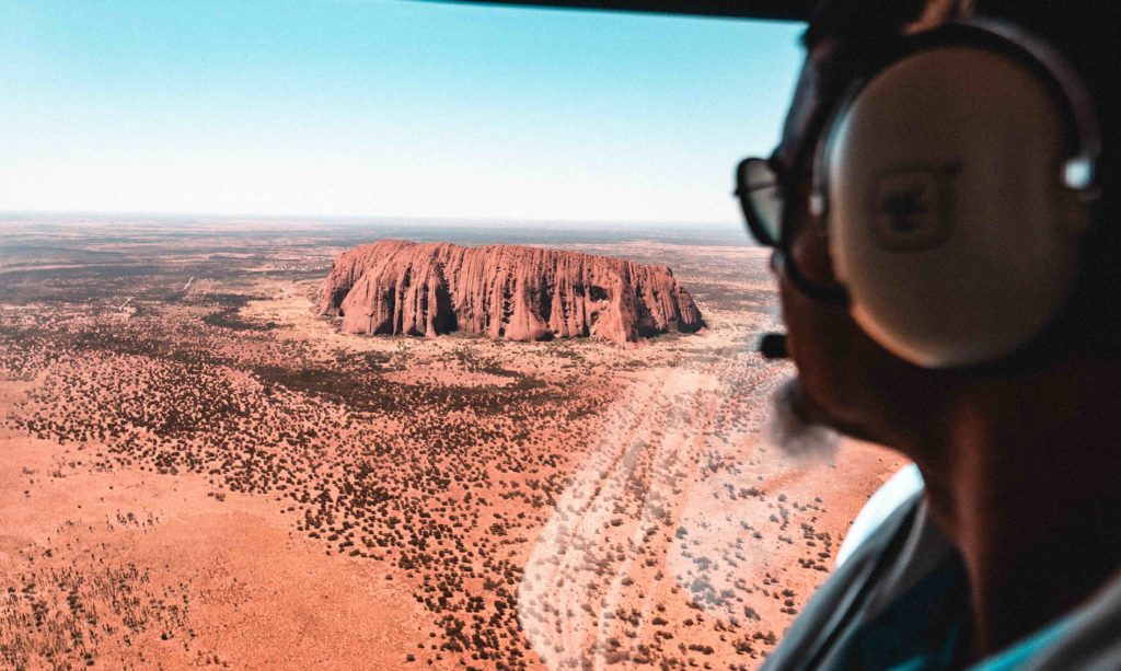 Aerial view of Uluru red rock in Australia from a helicopter.