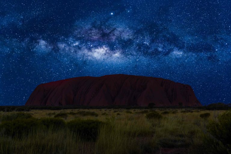 Uluru’s majestic beauty under the star-studded sky.