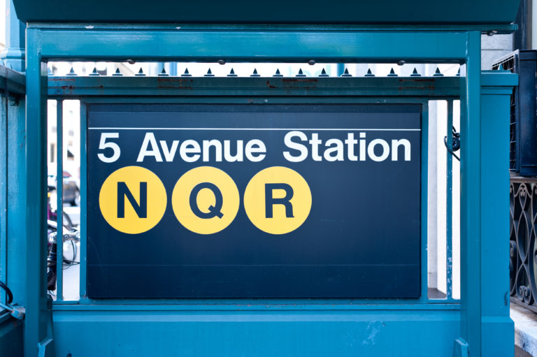 Close up view of the subway entrance sign at 5th Avenue, New York USA