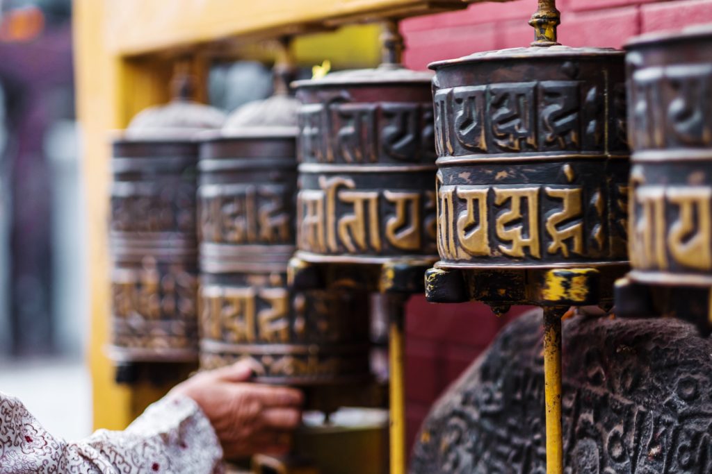 Boudhanath Stupa in Kathmandu, Nepal, adorned with prayer wheels.