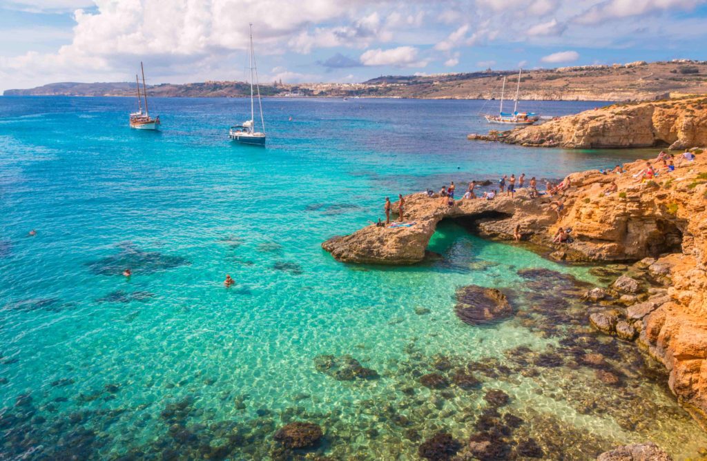 Crystal-clear water enchants in the Blue Lagoon on the island of Comino, Malta.