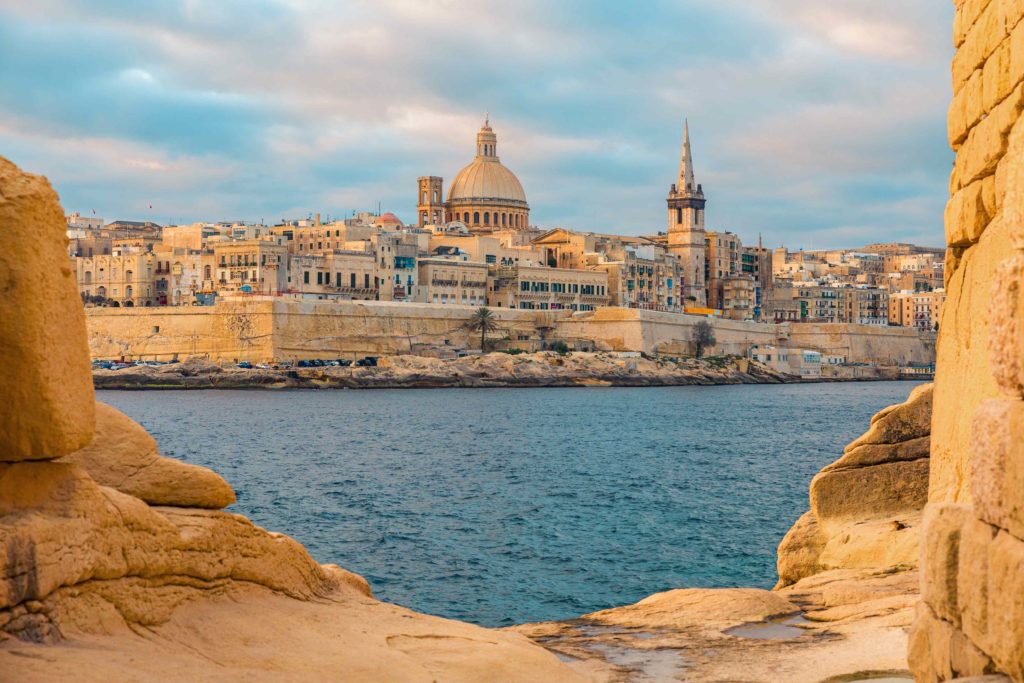 Sunrise in Valletta, Malta's old town, viewed from Sliema across Marsamxett harbor.