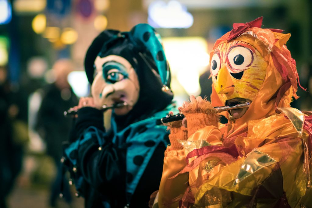 Freie Strasse in Basel during carnival, featuring a participant adorned in a handmade and distinctive costume, showcasing the unique artistry of each mask.