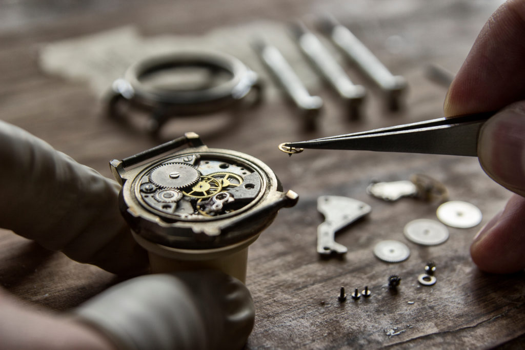 Watchmaker is repairing the mechanical watches in his workshop in Switzerland