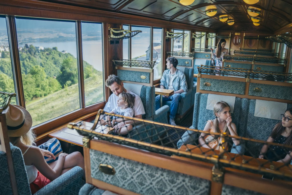 Families aboard the Golden Pass train, enjoying a scenic and memorable journey through the breathtaking landscapes of Switzerland.