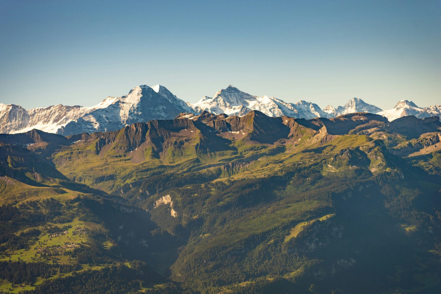 Breathtaking panoramic view of the majestic Eiger and Jungfrau mountains in the Swiss Alps.