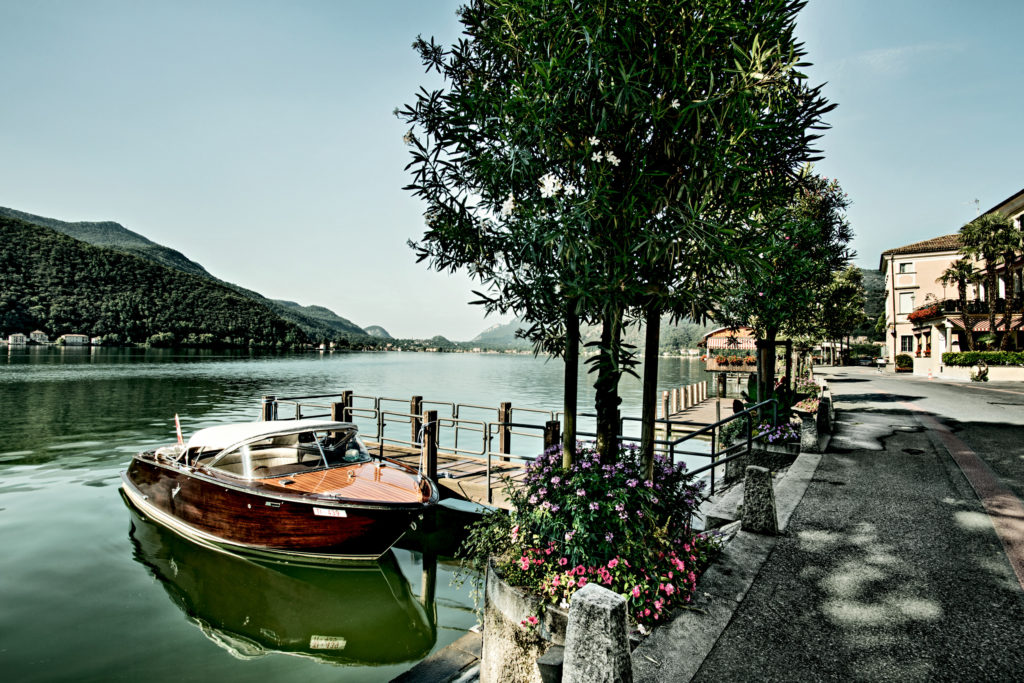 A boat docked at a serene lake's dock, surrounded by nature's beauty