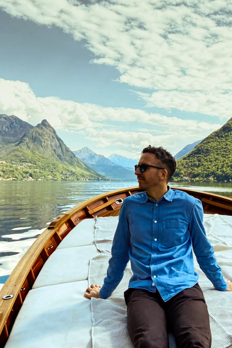 Sitting on the back of a boat enjoying the serene waters.