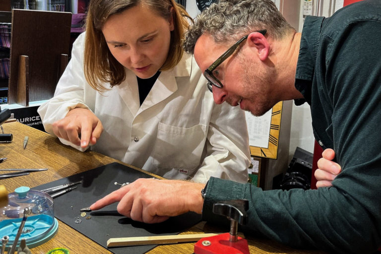 Duo working together at a watch making table