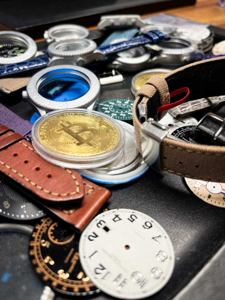 A table with different watches and other items used for making watches.