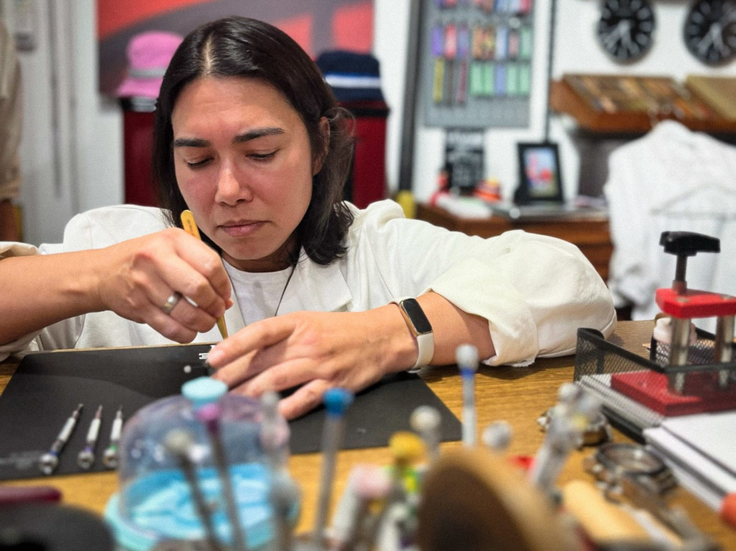 A skilled watch artisan meticulously working on a watch