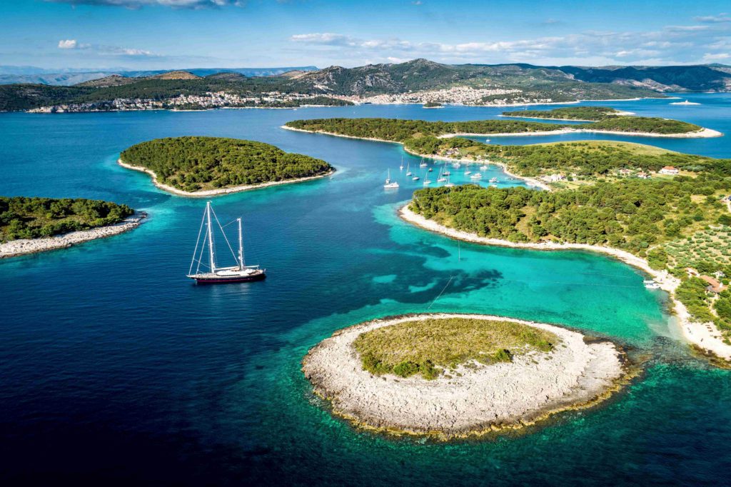 Aerial view of the Paklinski Islands in Hvar, Croatia captures turquoise water bays with luxurious yachts and sailboats.