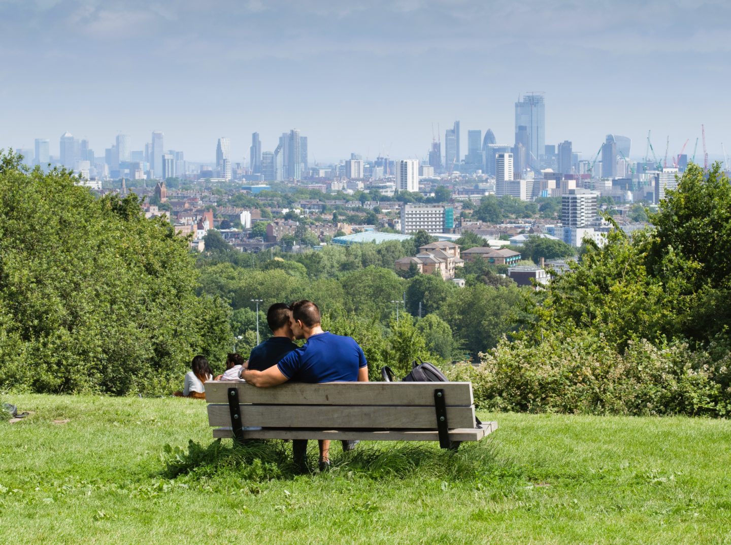 Couple sharing a romantic moment while capturing the breathtaking views of the city from the highest point of Hampstead Heath
