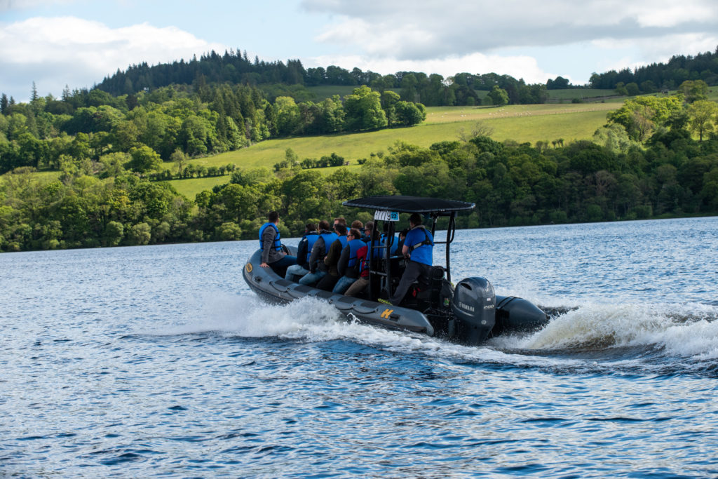 A boat with a group crosses Loch Lomond during an event in Scotland.