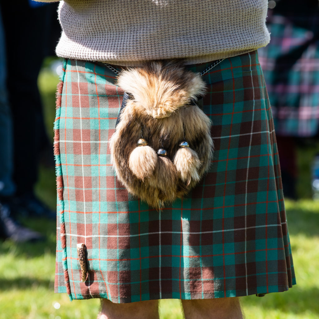 A man wears a kilt with a sporran.