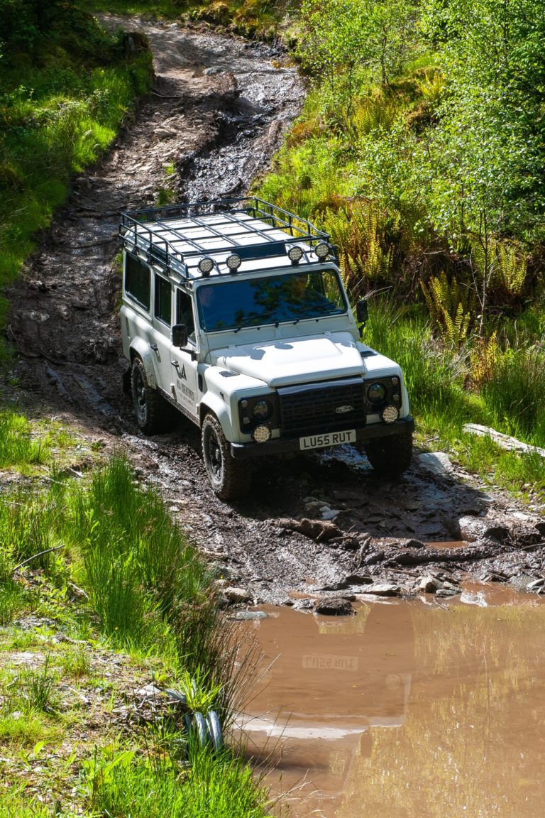 A Land Rover drives over the mud during an event in Scotland.