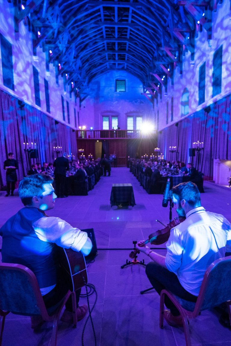 A violonist and a guitar player entertain the guests during the gala dinner at Stirnling Castle during an event in Scotland.