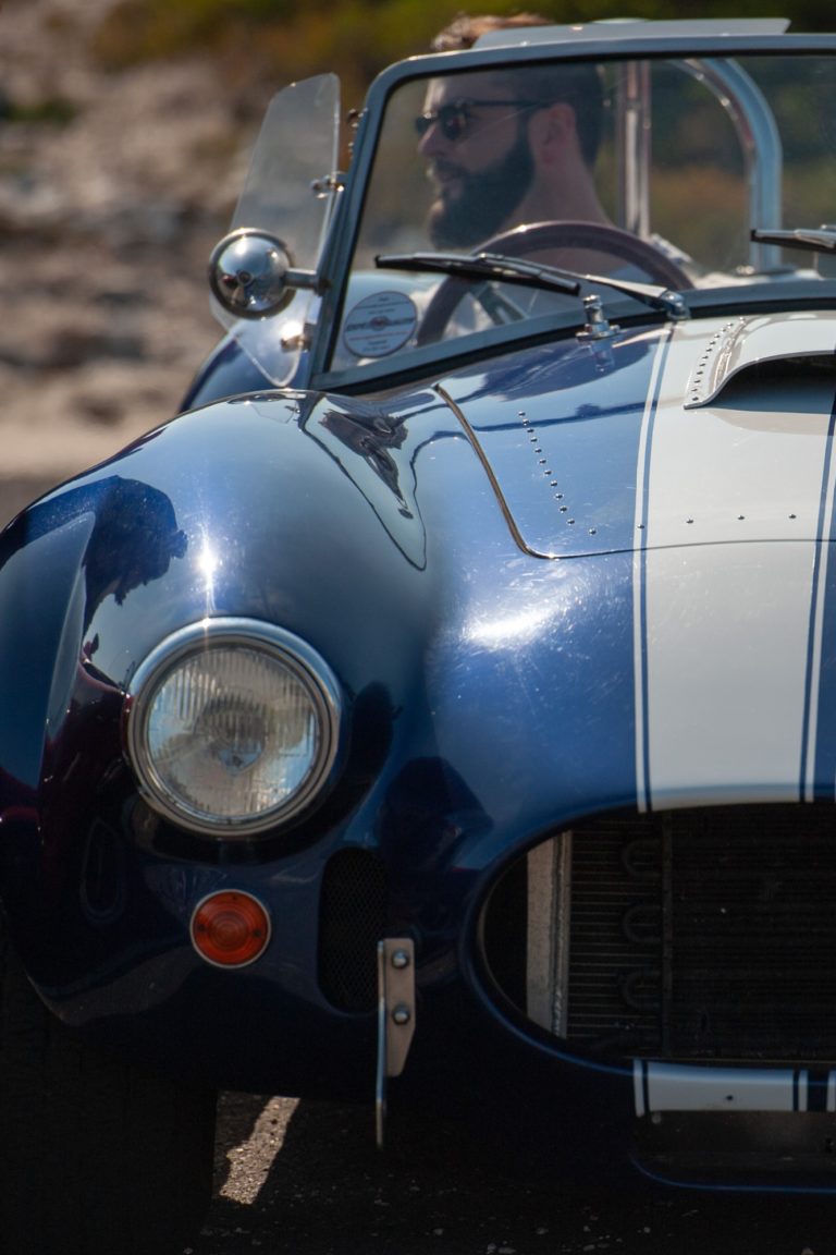 A man drives a vintage car in Cape Town.
