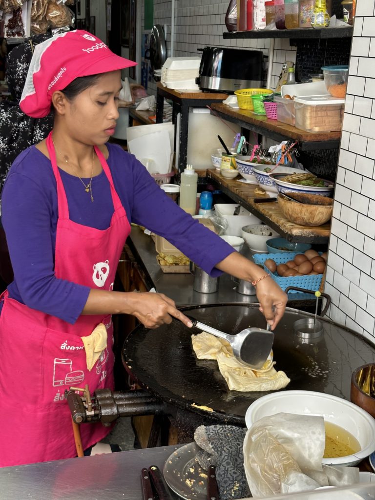 A woman prepares a sweet treat on the roadside in Phuket.