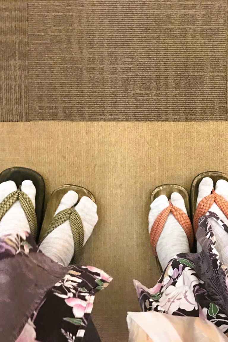 The picture shows women's feet wearing socks and flip-flops.