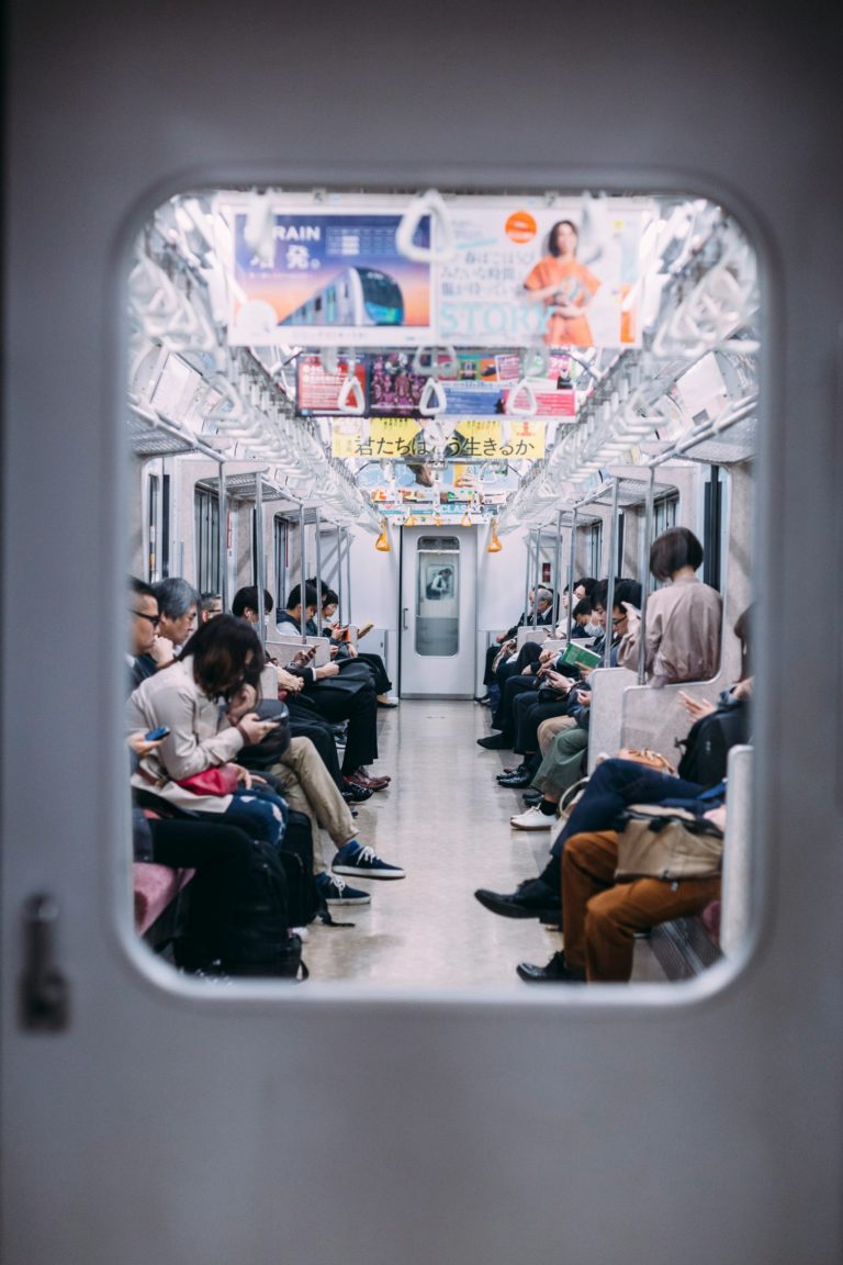 Passengers sitting on a train in Tokyo, Japan.