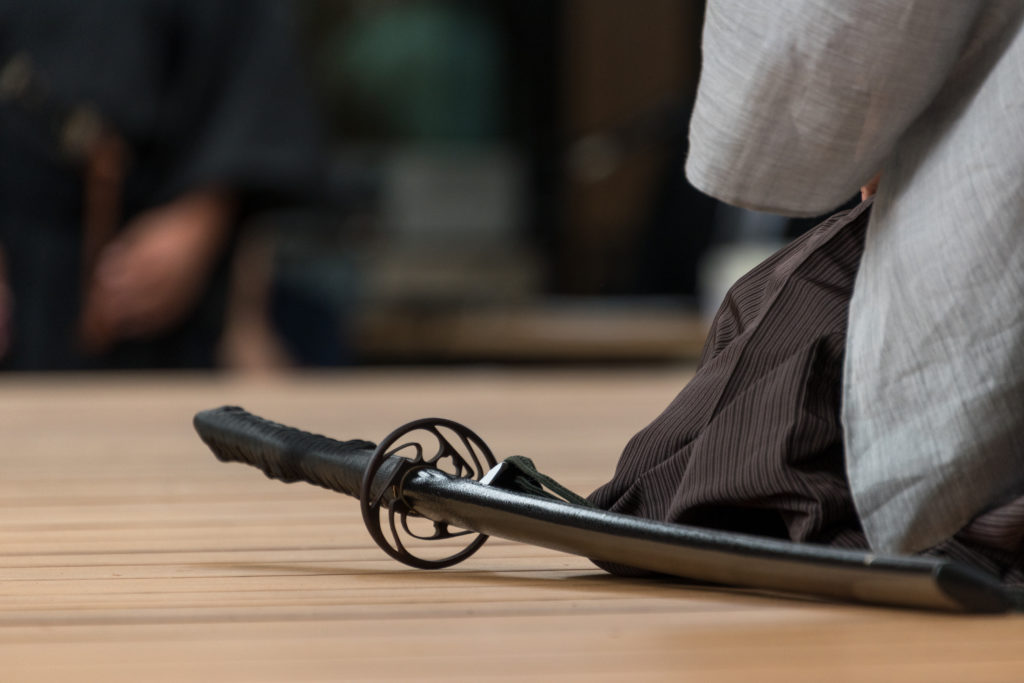 A man holds a samurai sword during a samurai sword lesson.